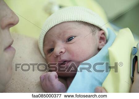 Newborn baby lying on mother's chest View Large Photo Image Stock Photo - Newborn baby lying on mother's chest. Fotosearch