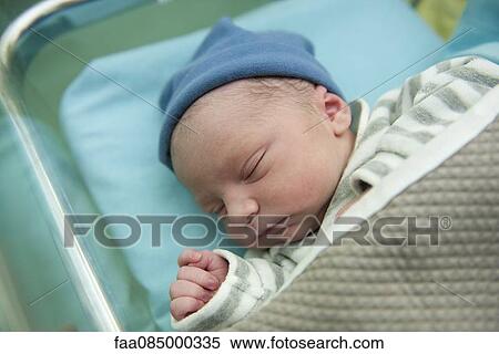 Stock Photography - Newborn baby sleeping. Fotosearch