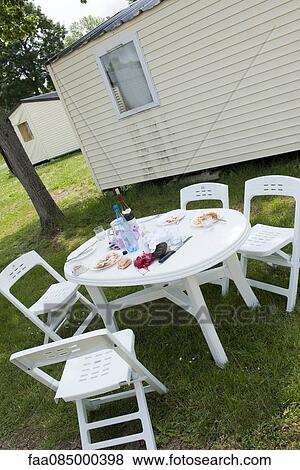 Plates left on outdoor table after meal View Large Photo Image Stock Photo - Plates left on outdoor table after meal. Fotosearch