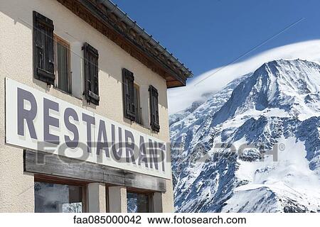 Restaurant with snow-capped mountain in background View Large Photo Image Stock Image - Restaurant with snow-capped mountain in background. Fotosearch