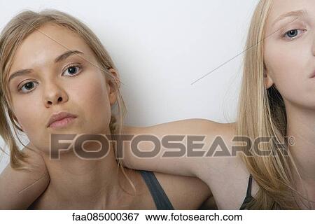 Stock Photo - Teenage girl with friend, portrait. Fotosearch