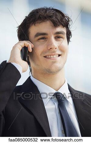 Young executive talking on cell phone, portrait View Large Photo Image Stock Image - Young executive talking on cell phone, portrait. Fotosearch