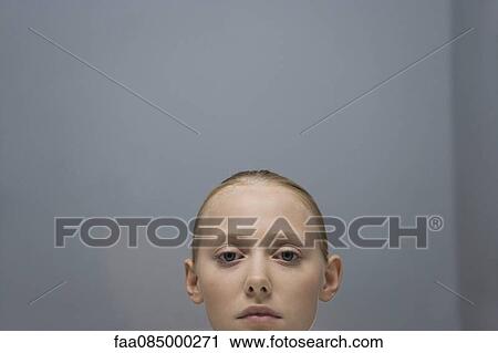 Stock Image - Young woman, cropped portrait. Fotosearch