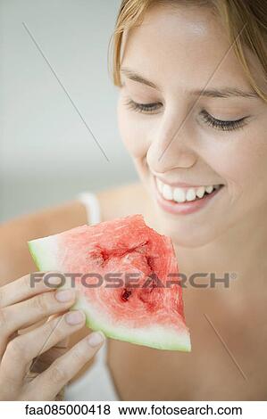 Young woman eating watermelon View Large Photo Image Stock Photo - Young woman eating watermelon. Fotosearch