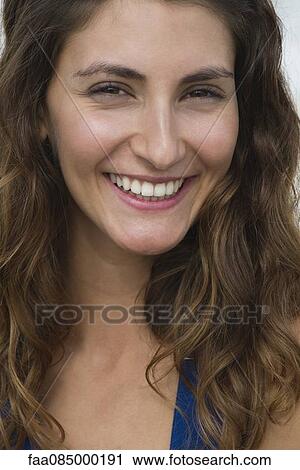 Young woman smiling, portrait View Large Photo Image Stock Image - Young woman smiling, portrait. Fotosearch