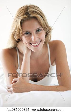 Stock Photography - Young woman smiling, portrait. Fotosearch