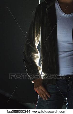 Young woman standing with hand in pocket, cropped View Large Photo Image Picture - Young woman standing with hand in pocket, cropped. Fotosearch