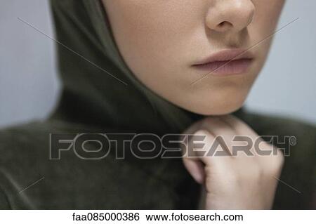 Young woman wearing hood, cropped View Large Photo Image Stock Photograph - Young woman wearing hood, cropped. Fotosearch