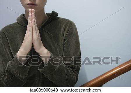 Young woman with hands clasped in prayer, cropped View Large Photo Image Stock Photo - Young woman with hands clasped in prayer, cropped. Fotosearch