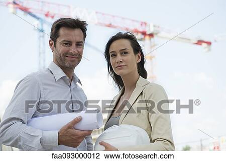 Stock Image - Architects in construction site, portrait. Fotosearch