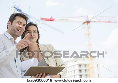 Stock Photo - Architects survey construction project. Fotosearch