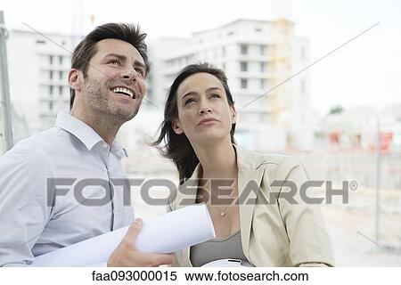 Architects surveying construction site View Large Photo Image Stock Photography - Architects surveying construction site. Fotosearch