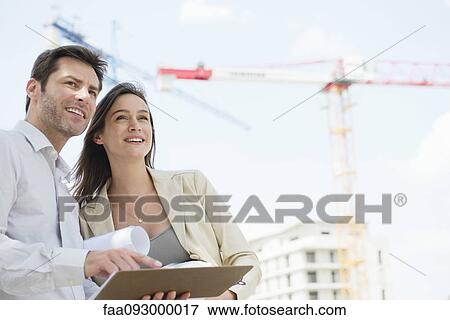 Architects surveying constrution project View Large Photo Image Stock Photo - Architects surveying constrution project. Fotosearch