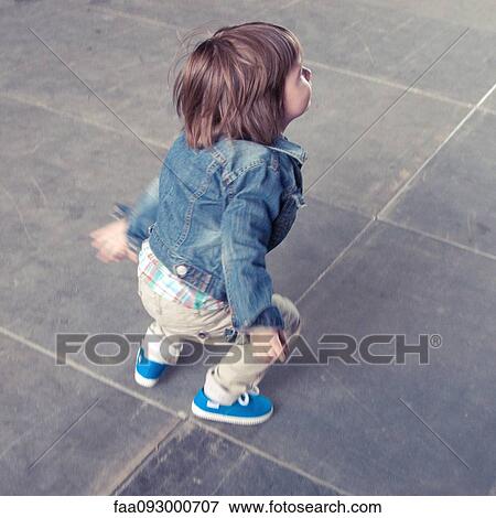 Stock Photo - Boy jumping outdoors. Fotosearch