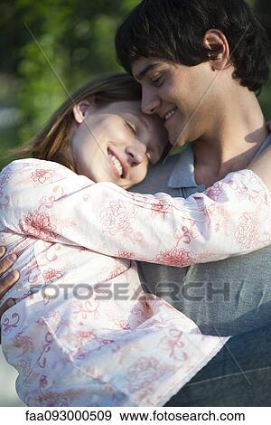 Stock Photo - Boyfriend carrying girlfriend, portrait. Fotosearch