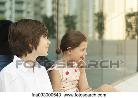 Brother and sister sitting together outdoors View Large Photo Image Stock Image - Brother and sister sitting together outdoors. Fotosearch