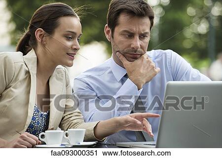 Business associates collaborating on project using laptop computer View Large Photo Image Stock Image - Business associates collaborating on project using laptop computer. Fotosearch