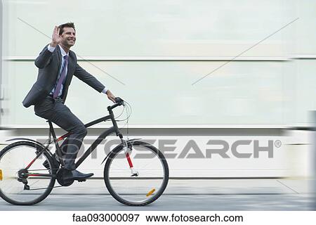 Businessman riding bicycle View Large Photo Image Stock Photo - Businessman riding bicycle. Fotosearch