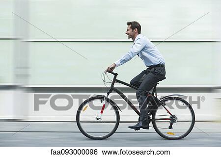 Businessman riding bicycle View Large Photo Image Stock Photograph - Businessman riding bicycle. Fotosearch