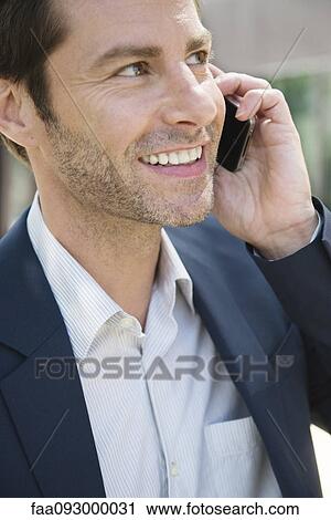 Businessman talking on cell phone View Large Photo Image Stock Image - Businessman talking on cell phone. Fotosearch