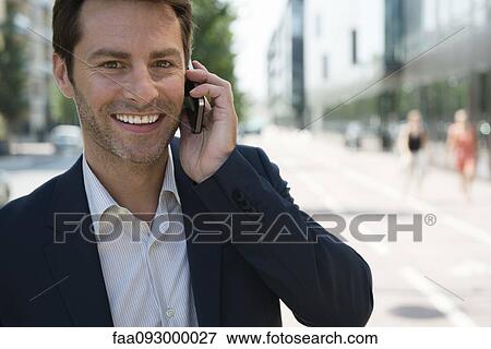 Businessman talking on cell phone View Large Photo Image Stock Photo - Businessman talking on cell phone. Fotosearch