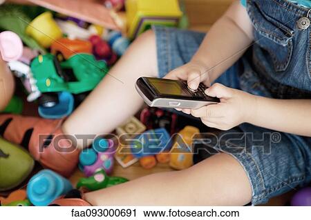 Child playing with cell phone, cropped View Large Photo Image Stock Image - Child playing with cell phone, cropped. Fotosearch