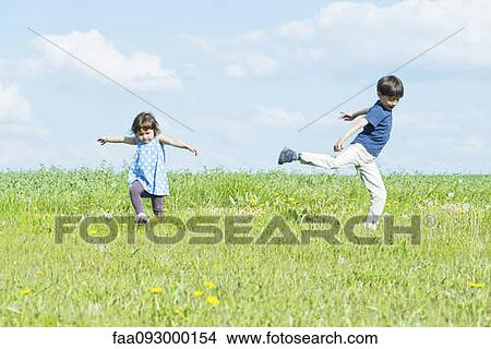 Children running in field with arms out View Large Photo Image Picture - Children running in field with arms out. Fotosearch