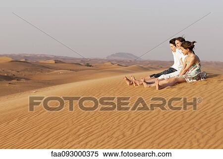 Children sitting together on sand dune looking at view View Large Photo Image Stock Photography - Children sitting together on sand dune looking at view. Fotosearch