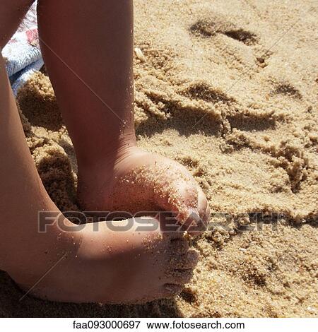 Child's bare feet covered in sand, close-up View Large Photo Image Stock Photo - Child's bare feet covered in sand, close-up. Fotosearch