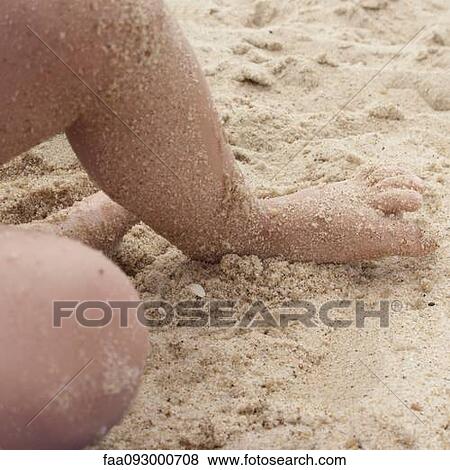 Child's foot covered in sand at the beach View Large Photo Image Stock Photo - Child's foot covered in sand at the beach. Fotosearch