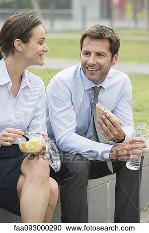 Coworkers having lunch together outdoors View Large Photo Image Stock Image - Coworkers having lunch together outdoors. Fotosearch