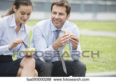 Coworkers having lunch together outdoors View Large Photo Image Stock Photo - Coworkers having lunch together outdoors. Fotosearch