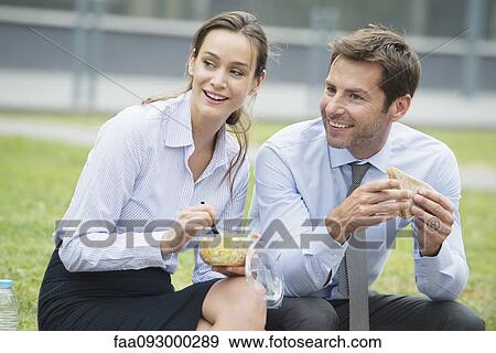 Coworkers having lunch together outdoors View Large Photo Image Stock Photo - Coworkers having lunch together outdoors. Fotosearch
