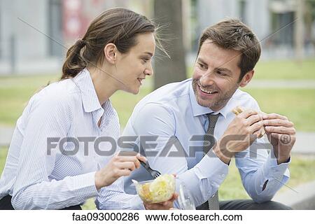 Coworkers having lunch together outdoors View Large Photo Image Stock Photograph - Coworkers having lunch together outdoors. Fotosearch