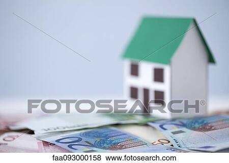 Stock Photo - Debt overwhelms investment real estate value during recession. Fotosearch