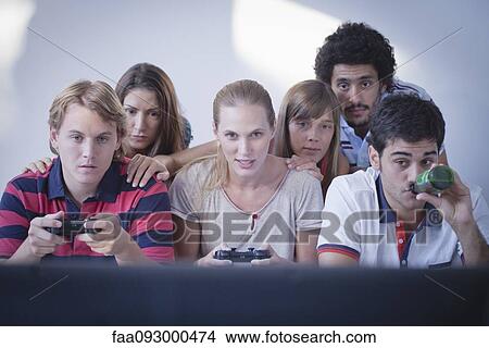 Picture - Friends playing video games together. Fotosearch