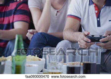 Friends playing video games together View Large Photo Image Stock Image - Friends playing video games together. Fotosearch