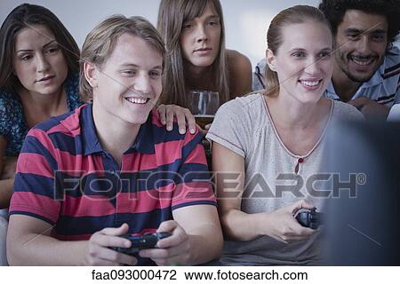 Friends playing video games together View Large Photo Image Stock Image - Friends playing video games together. Fotosearch