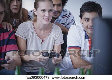 Friends playing video games together View Large Photo Image Stock Image - Friends playing video games together. Fotosearch