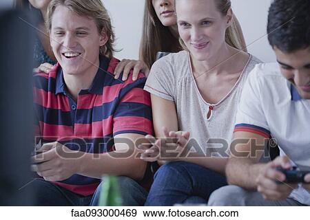 Stock Photo - Friends playing video games together. Fotosearch