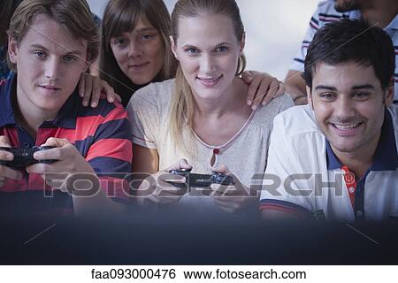 Friends playing video games together View Large Photo Image Stock Photograph - Friends playing video games together. Fotosearch