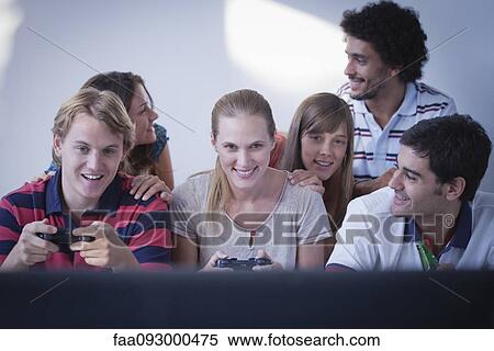 Stock Photography - Friends playing video games together. Fotosearch