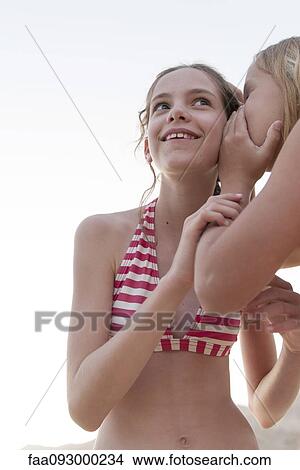 Friends telling secrets View Large Photo Image Picture - Friends telling secrets. Fotosearch