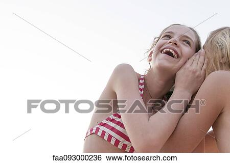 Friends telling secrets View Large Photo Image Stock Photograph - Friends telling secrets. Fotosearch