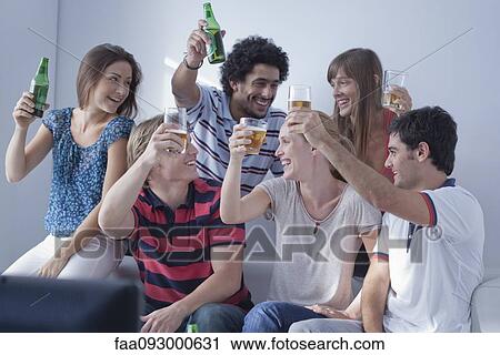 Friends watching sports match on television together celebrate team's victory View Large Photo Image Stock Image - Friends watching sports match on television together celebrate team's victory. Fotosearch