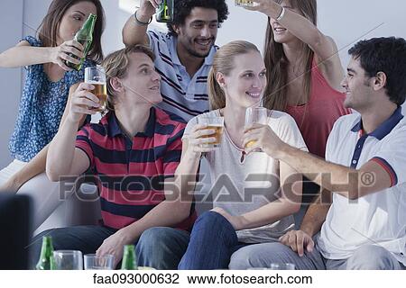 Friends watching sports match on television together celebrate View Large Photo Image Stock Image - Friends watching sports match on television together celebrate. Fotosearch