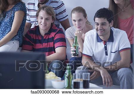 Friends watching sports match on television together View Large Photo Image Stock Photo - Friends watching sports match on television together. Fotosearch