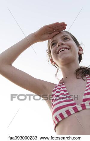Stock Image - Girl in bathing suit looking at view. Fotosearch