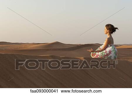Girl meditating in desert View Large Photo Image Stock Image - Girl meditating in desert. Fotosearch