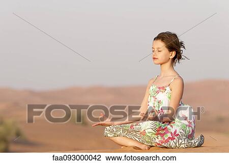 Girl meditating in desert View Large Photo Image Stock Image - Girl meditating in desert. Fotosearch
